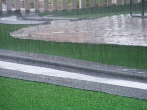 rain falling on artificial turf seam on top of base panels