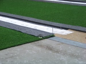 artificial turf seam on top of base panels