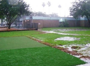 heavy rain falling on artificial turf and real grass