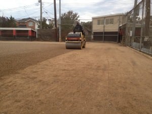 dirt roller compacting dirt gravel for baseball diamond