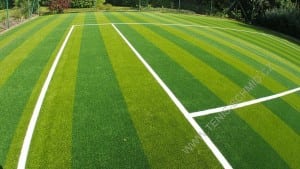 completed photo of artificial turf tennis court with sand filling