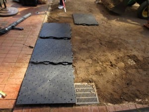 ultrabasesystems panels ready to be laid on dirt in marriot courtyard