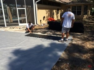 installers laying down ultrabasesystems panels on geosynthetic fabric