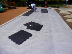team piecing ultrabasesystems panels on fabric for artificial turf playground