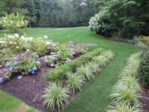 artificial lawn turf and putting green near flower bed