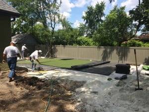 team installs turf over ultrabasesystems panels for yard installation