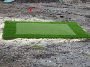 small square of artificial turf and trim