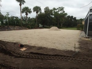 gravel fill material applied to installation site for backyard soccer field