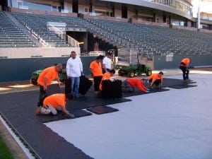 installers unload and place ultrabasesystems panels on geotextile fabric for football field installation