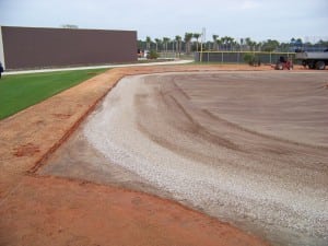 an athletic field that has had dirt compacted in prep for artificial turf