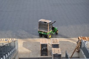 tractor moves a pallet of base panels