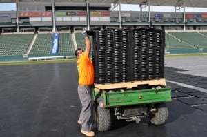 field installer unloading ultrabasesystems panels onto football field
