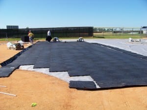 installers complete the first rows of base panel installation during artificial field install