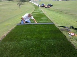 man connecting tee line turf pieces