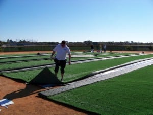 rolled out artificial turf on field