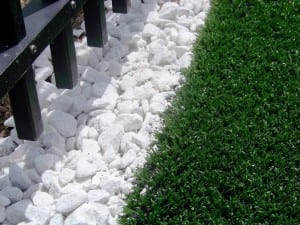 artificial grass installed next to white rocks