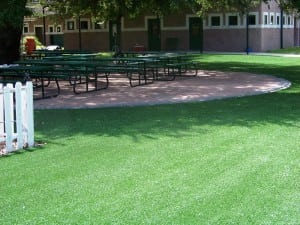 rest area with park benches on soccer field made from artificial turf