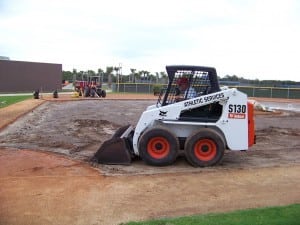 front end loader at artificial turf field installation site