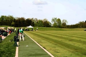golfers hitting off completed artificial tee line