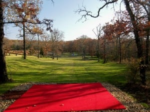 red artificial putting green turf at snag golf course