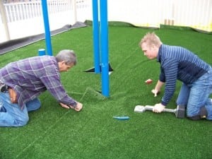 installers cut and seam together multiple pieces of artificial grass