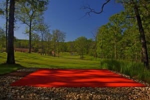 red artificial putting green on snag golf course