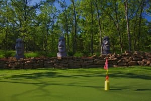 stone tiki statues on completed snag putting green installation
