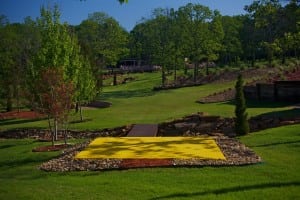 completed snag golf course with yellow outdoor synthetic putting green next to bridge