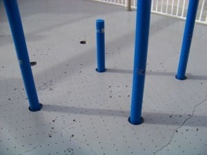 playground panels cut to fit around existing poles