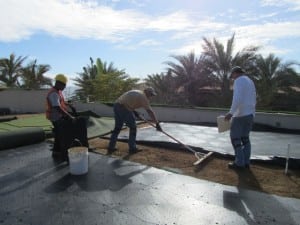 team sweeps dirt under ultrabasesystems panels for rooftop putting installation