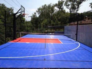 completed blue and red backyard basketball court