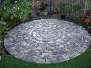 completed backyard paver installation next to artificial grass