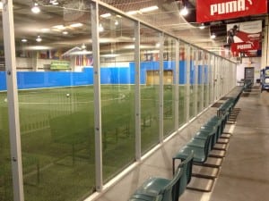 finished glass wall around indoor artificial soccer field
