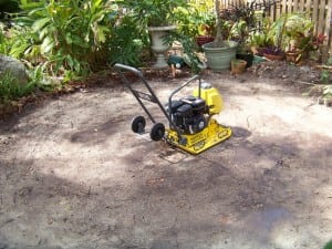 vibratory plate compactor used in backyard paver installation