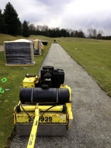 machine flattens gravel for tee line turf installation at Beacon Hall Golf Club
