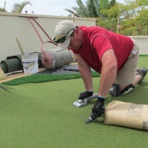 installer pressing seam of two turf pieces
