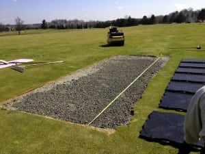 gravel base being measured for Beacon Hall tee line turf installation