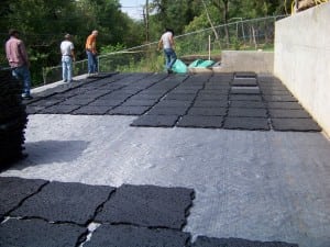 a group of installers lay ultrabasesystems base panels out on geotextile fabric