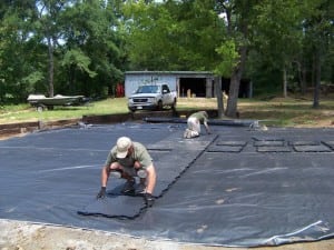 men lay down ultrabasesystems base panels for putting area