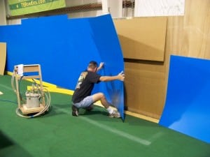 man removing old dasher boards during indoor soccer field installation