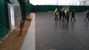 men walking on connected ultrabasesystems panels for indoor soccer field installation