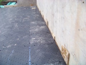 wall spacers used for base panels during backyard basketball court installation