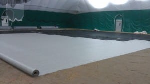 geo textile fabric rolled out while base panels are connected for soccer field turf installation