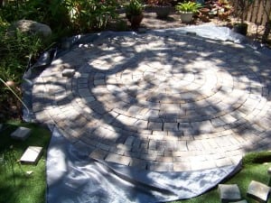 backyard paver installation with artificial turf