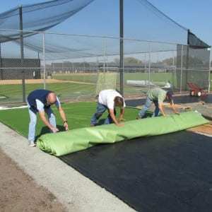 team rolling out artificial turf for Tampa Spring training complex baseball field turf installation