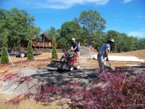 installers clearing site for putting green installation