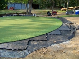 artificial putting green turf and fring laid out on top of ultrabasesystems panels