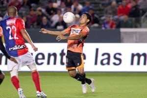 soccer ball approaches soccer player's face