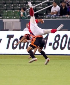 two players colliding on soccer field