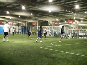 men training on indoor artificial turf soccer field